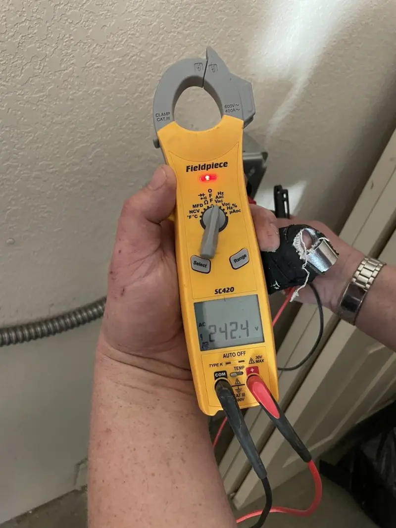 Voltage testing with clamp meter during Recessed Lighting Installation in Crosby